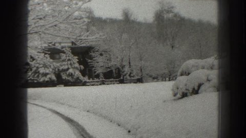 MARTINSBURG WEST VIRGINIA 1938: snow covers building and trees during winter