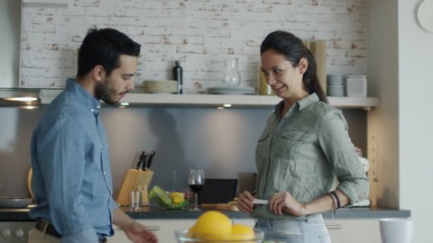 In the Kitchen Gorgeous Girl Shows Pregnancy Test Result to Her Boyfriend. Both Happily Embrace. Slow Motion. Shot on RED Cinema Camera in 4K (UHD).