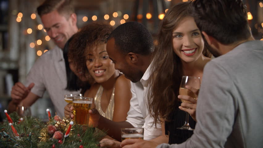 Friends making a toast at a Christmas party in a bar | Shutterstock HD Video #21728020