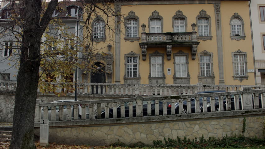 Beautiful old  building at Corvin Square in Budapest.  Cars pass in front of the. There is quiet autumn day.