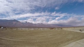 Panning and zooming timelapse of clouds above mountains, on a windy day, in Death valley, California, in United states of America