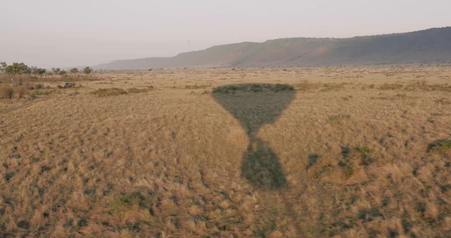 The shadow of a hot air balloon as it floats over the Kenyan savanna. 