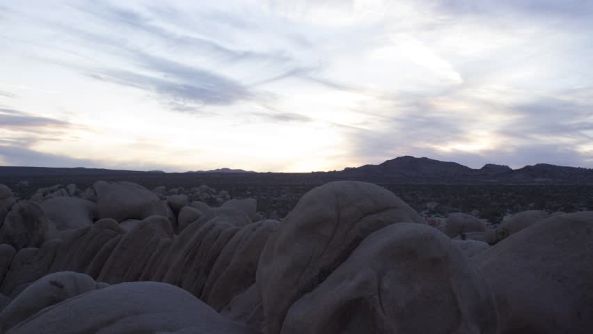 Dramatic Clouds Race over Joshua Tree Campsite during a Vibrant Sunset HD Timelapse