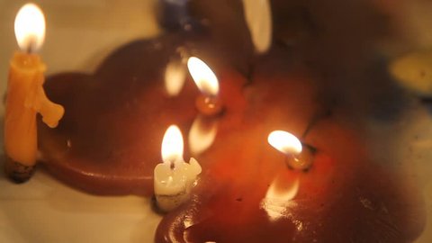 slow motion, Burning candles in a bath of wax
