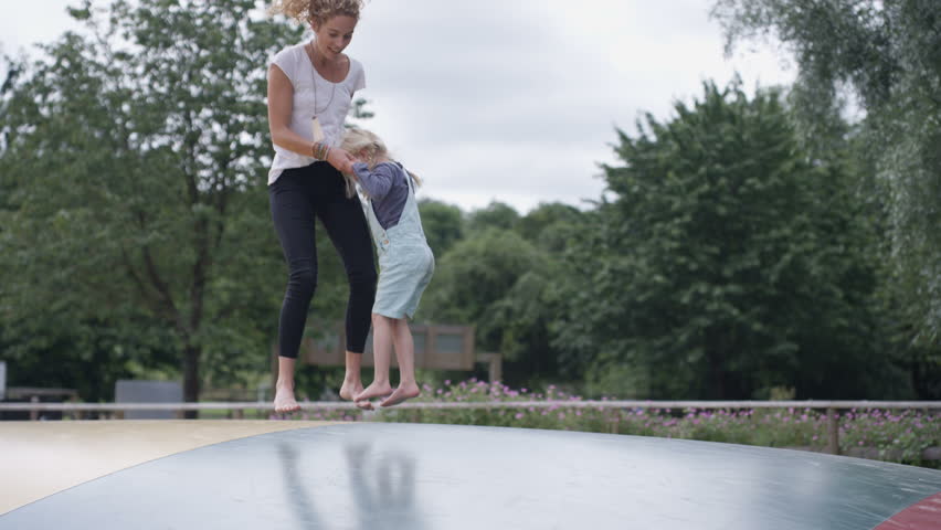 4K Parents and children having fun, jumping on inflatable at activity center (UK-Oct 2016)