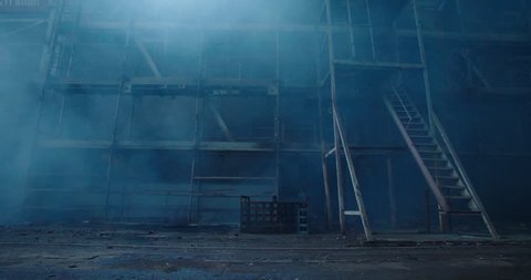 Old fabric manufactory building in the smoke. Dark Space atmosphere. Abandoned factory hall with broken glass on windows.Apocalyptic scene with destroyed warehouse. Video Stok