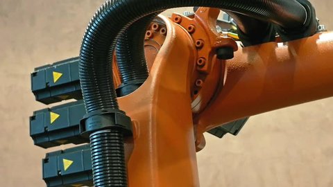 Industrial robotics robot arm for welding and assembling with three dimensional 3d freedom movement. Modern technology video footage.