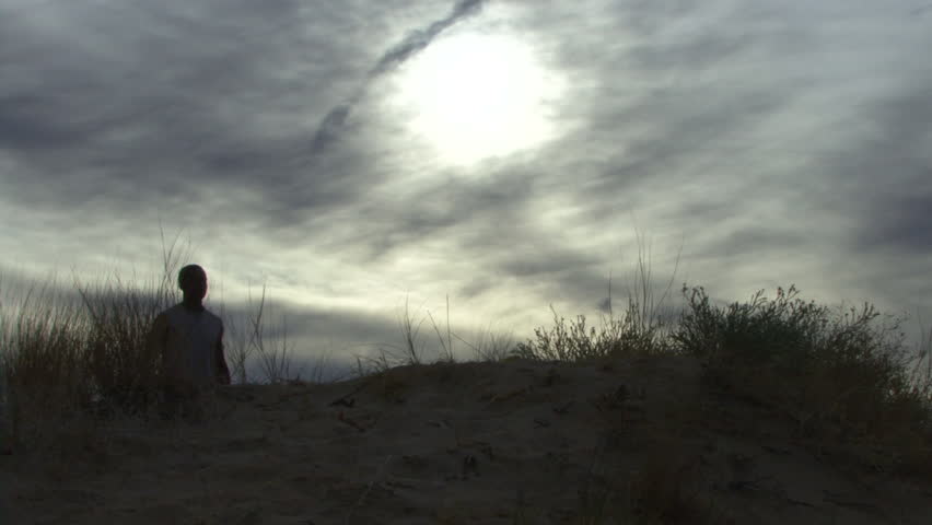 Male walking up hill and relaxing