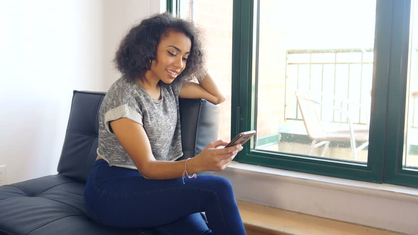 African American girl talking on mobile smart phone in urban loft  | Shutterstock HD Video #21767671