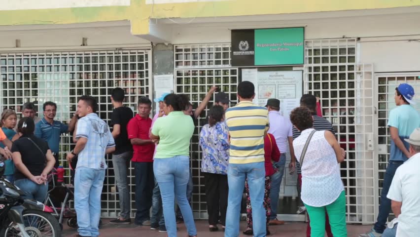 Cucúta, Colombia, Circa 2016: Venezuelans stand outside Columbia Border office awaiting entrance (HD)