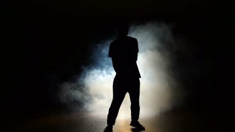 Dancer in a smoke on a black background