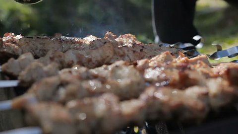 Barbecue With Delicious Grilled Meat On Grill pour marinade