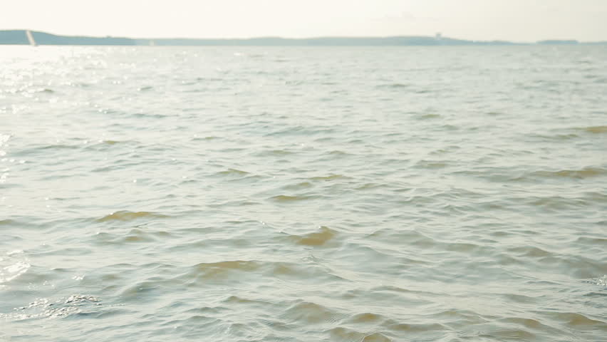 girl sitting on rocks on the coast and posing