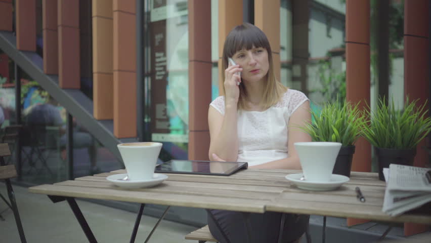 Businesswoman ends phonecall, outdoor. Steadicam shot. Royalty-Free Stock Footage #21783190