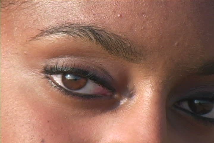 A young woman with beautiful eyes staring at the camera. 