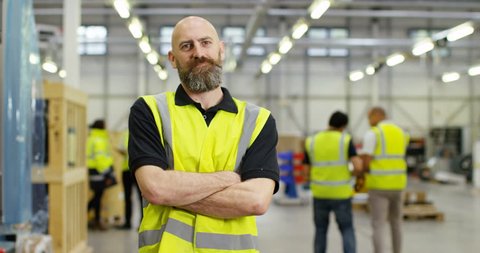 4k, Portrait of a cheerful and friendly male warehouse manager. Slow motion.