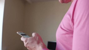 Man scrolling app in his phone at home. 4K close up steadicam video