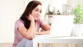 Happy young teenage girl is chatting online to boyfriend having along distance relationship