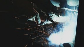 Welder of Metal Welding with sparks and smoke in  manufacturing 