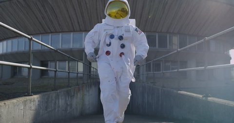 4K Funny astronaut doing a dance as he walks away from mission control building. (UK-Oct 2016)