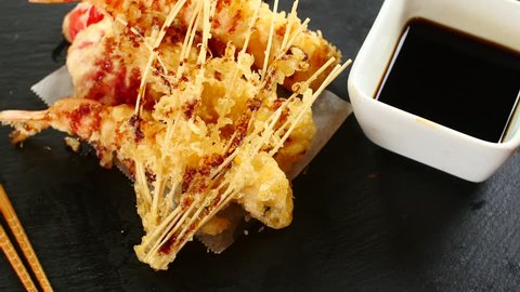 Fried shrimp tempura served with soy sauce. Japanese dish of seafood.