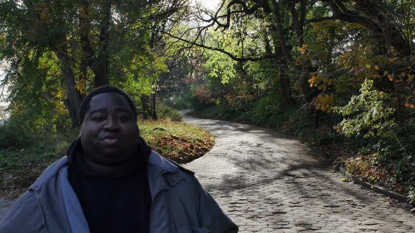 A Man Smiles at the Entrance to A Fairy Tale Walkway, A Path in a Public Park