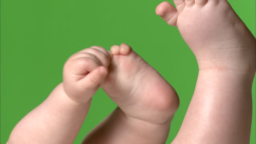 Green screen of baby grabbing feet