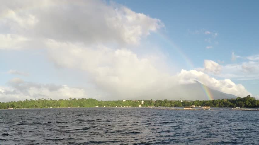 Rainbow Over Mountains behind Lake
