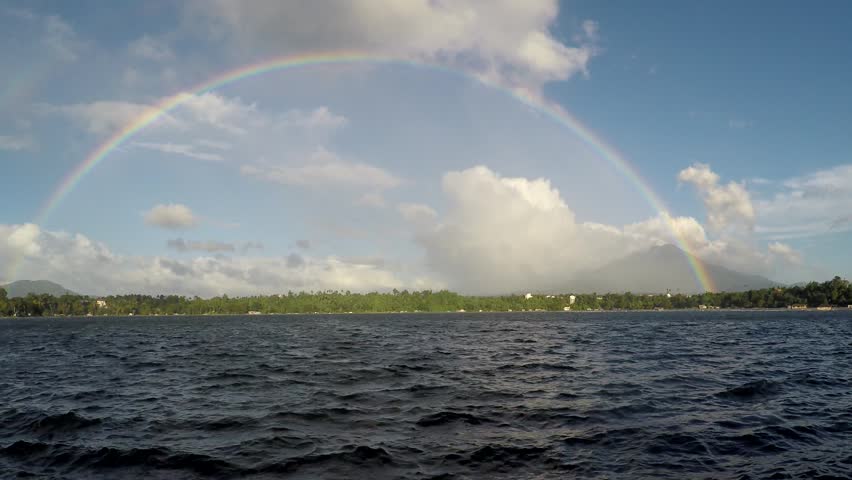 Rainbow Over Mountains behind Lake