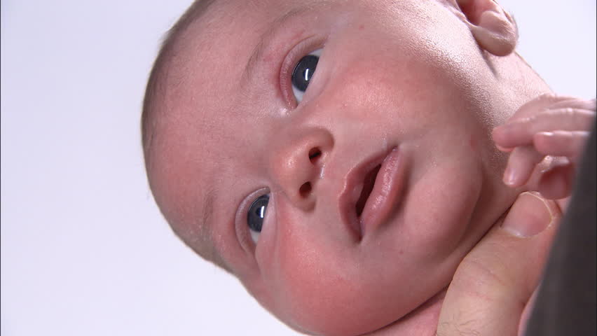 Closeup of newborn baby's face, left side