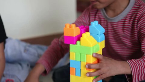Young Boy Building Skyscraper with Playing Blocks