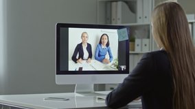 Businesswoman having video call on her computer with two female partners
