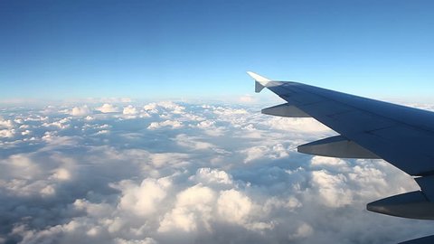 View of clouds through window of an airplane on a sunny day. 
Full high definition video 1920X1080.