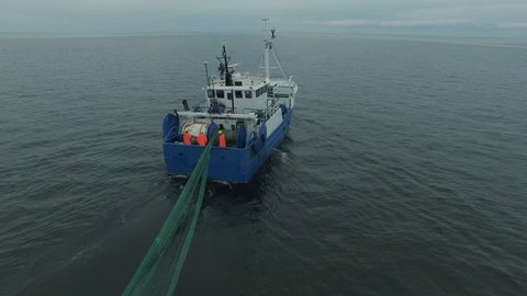 Aerial Shot of a Commercial Fishing Ship that Pulls Trawl Net. Shot on Phantom 4K UHD Camera.