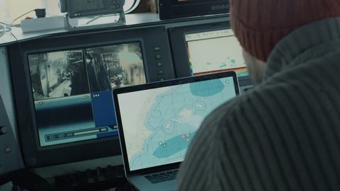 Captain of Commercial e-Commerce Container Ship Working with Sea Maps in his Cabin. Shipping and Logistics Concept of food and goods supply
