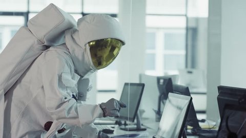 4K Funny astronaut working in room full of computers and doing a little dance (UK-Oct 2016)