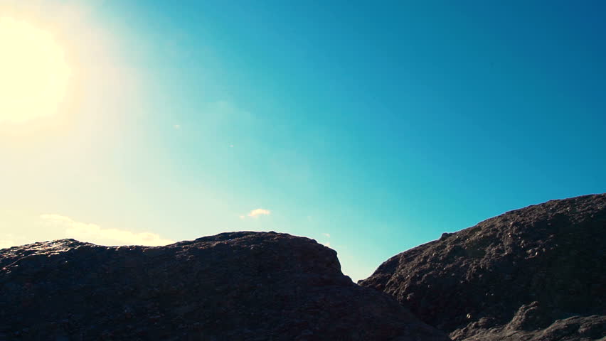 Man jumping over a gap high up on a mountain hike