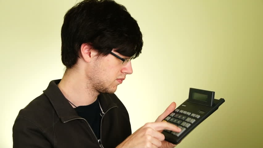 Young man calculating on his calculator.