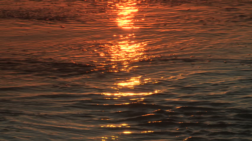 Golden sunlight reflected in the sea water