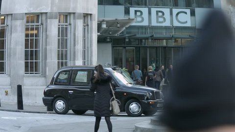 PORTLAND PLACE, REGENT STREET, LONDON - NOVEMBER 2, 2016. The entrance of BBC Broadcasting House in Portland Place, Regent Street, London. Black cab pulls out of the forecourt.