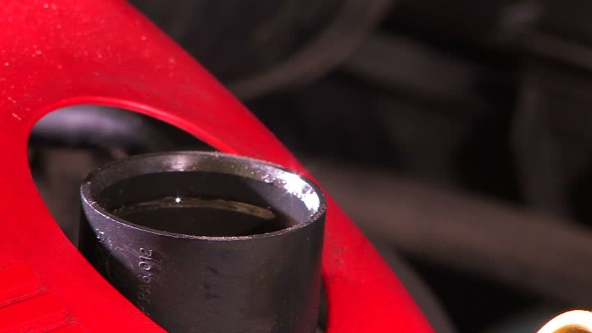 Man fills in engine oil - close-up 