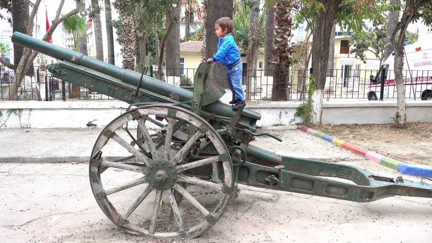 Kusadasi, Turkey - 26th of October, 2016:  4K Child on the top of artillery gun

