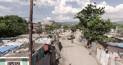 Low altitude aerial flying through a town in Jamaica.