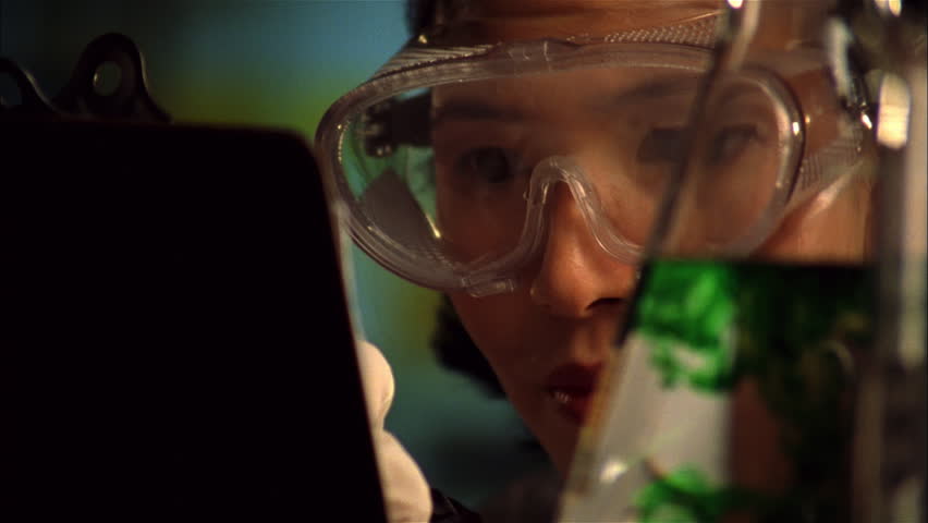 Chemist examines test tubes