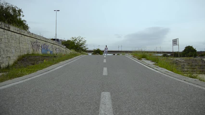 Young girl having fun. Downhill with long board . Outdoors, lifestyle.