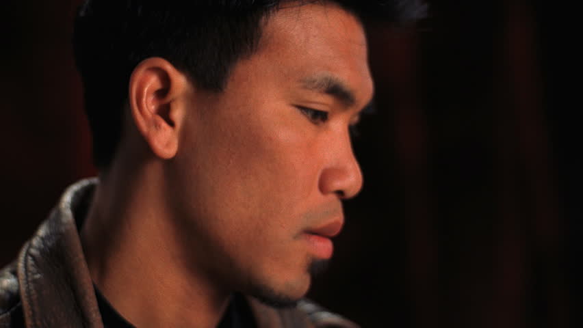 Closeup of serious young Asian man