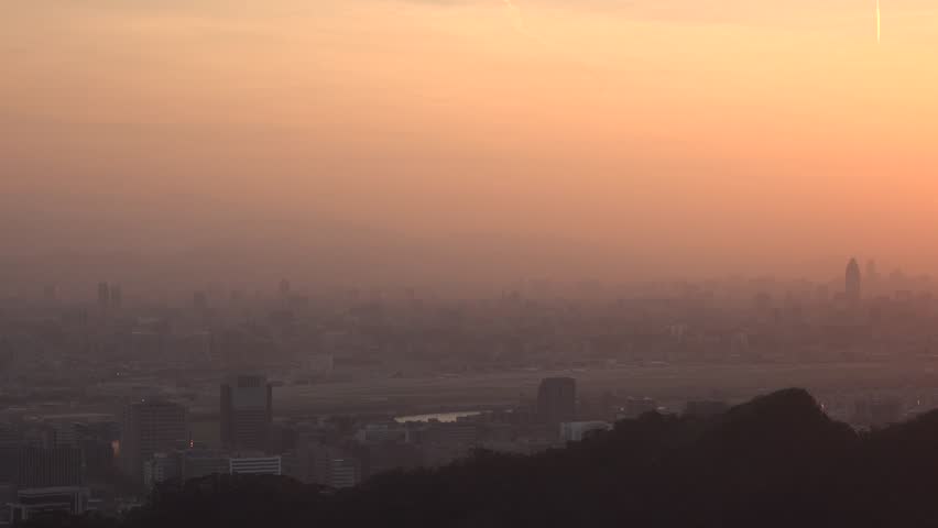 Beautiful sunset in Taipei city view from the mountains. Taiwan is a mountainous island, the island has the largest number and density of high mountains in the world. 4K