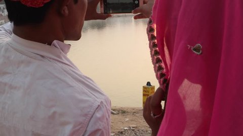 Indian couple taking photos on a mobile phone camera Pushkar, Rajasthan, india