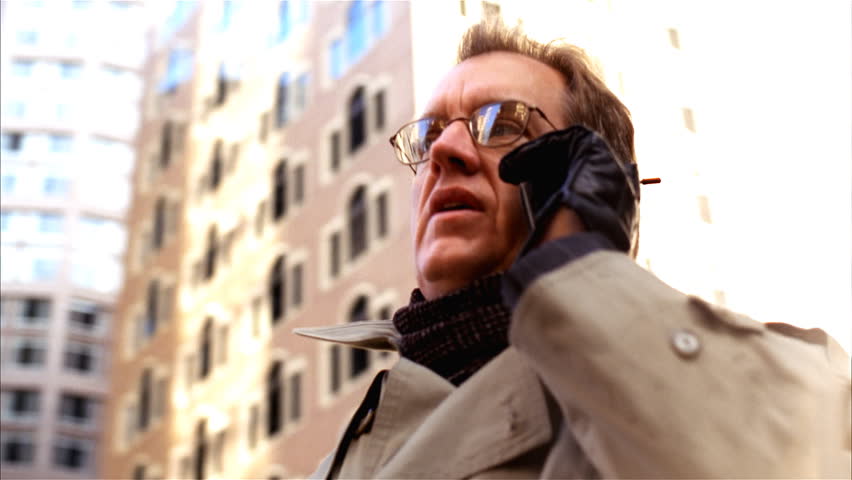 Steady camera shot of business man talking on cellphone