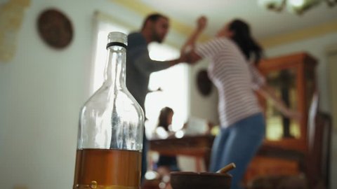 Social issues, abuse and violence on women, young drunk man hitting and beating girl at home after drinking alcohol. Angry husband fighting with abused wife
